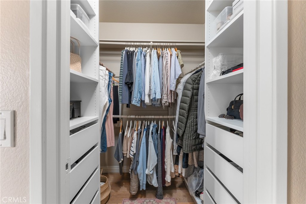 4021 North Larkspur Avenue Rialto, CA 92377 - Photo 24 of 40 a view of walk in closet with clothes and shoes