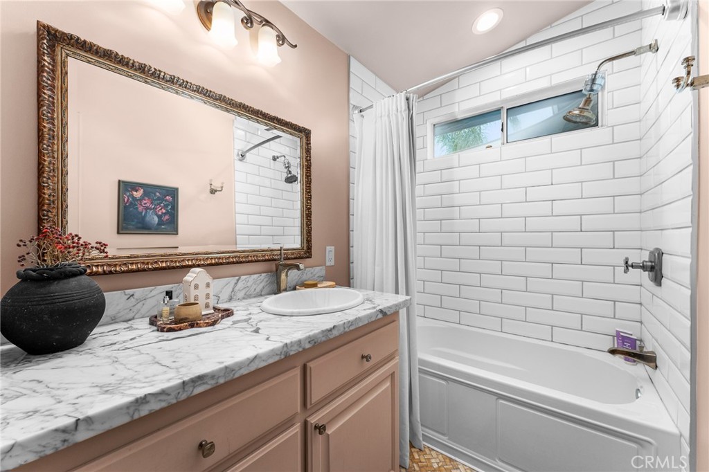 4021 North Larkspur Avenue Rialto, CA 92377 - Photo 25 of 40 a bathroom with a granite countertop sink mirror and bathtub