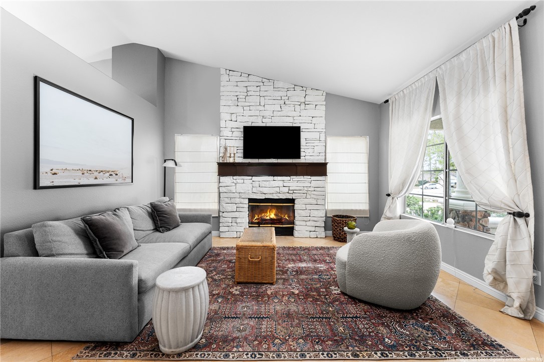 4021 North Larkspur Avenue Rialto, CA 92377 - Photo 8 of 40 a living room with furniture a flat screen tv and a fireplace