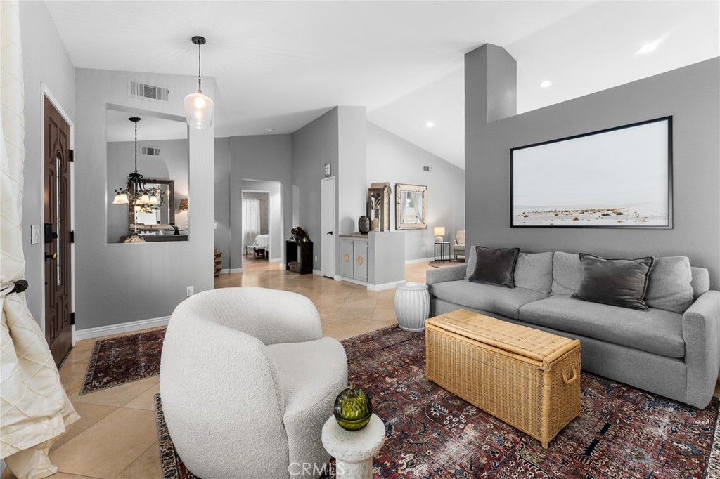 4021 North Larkspur Avenue Rialto, CA 92377 - Photo 10 of 40 a living room with furniture and a chandelier