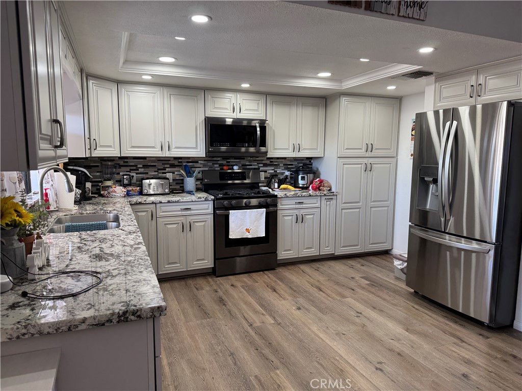 751 Rimrock Road Barstow, CA 92311 - Photo 11 of 33 a kitchen with stainless steel appliances granite countertop a sink stove and refrigerator