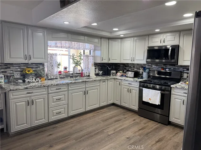 a kitchen with a white cabinets and window