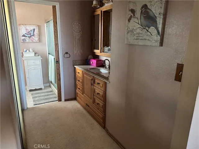 a view of a hallway with paintings on the wall