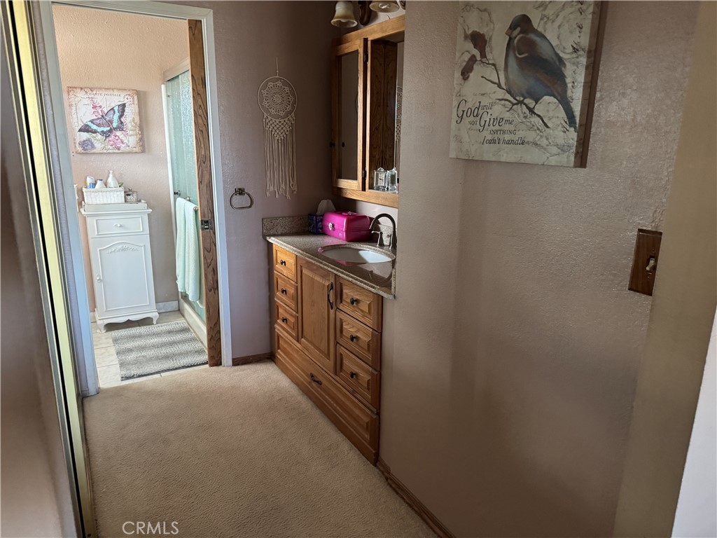 751 Rimrock Road Barstow, CA 92311 - Photo 19 of 33 a view of a hallway with paintings on the wall