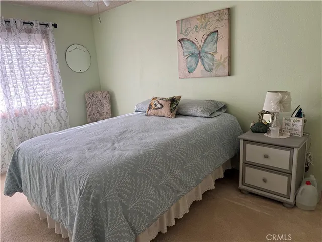 a bedroom with a bed and window