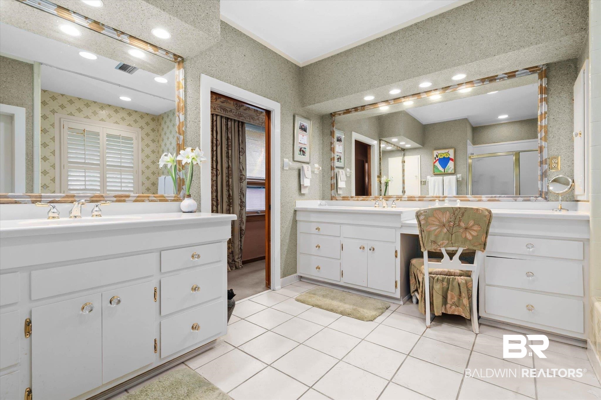 3500 Venetia Road Mobile, AL 36605 - Photo 19 of 56 Bathroom featuring dual vanities, white cabinetry with gold-tone hardware, and a large wall-mounted mirror