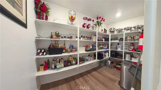 a living room with furniture a flat screen tv and a large window