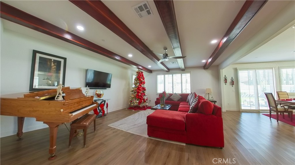 2411 Huron Road Rialto, CA 92377 - Photo 14 of 46 a living room with furniture a flat screen tv and a large window
