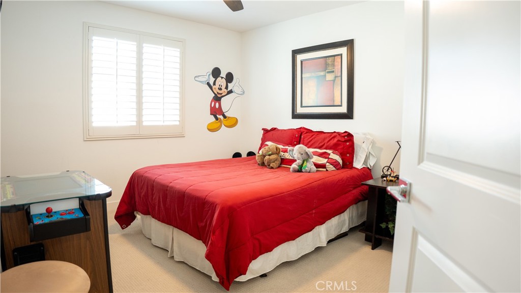 2411 Huron Road Rialto, CA 92377 - Photo 17 of 46 a bedroom with a bed and window