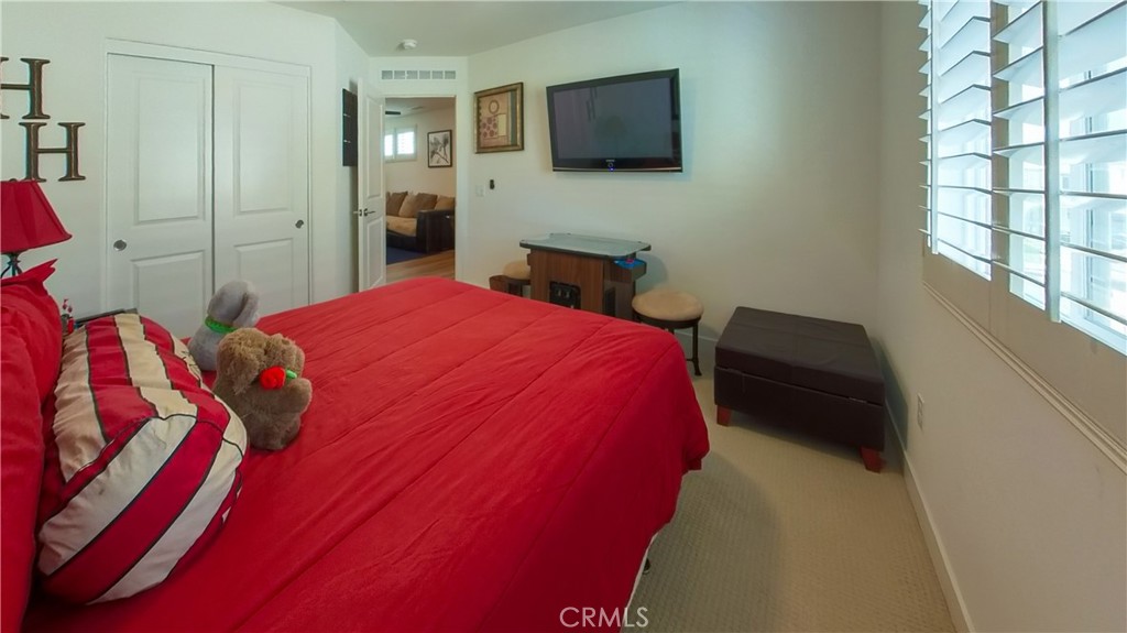2411 Huron Road Rialto, CA 92377 - Photo 18 of 46 a bedroom with a bed and a flat screen tv
