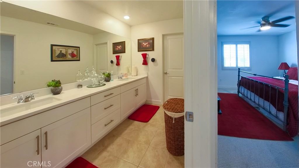 2411 Huron Road Rialto, CA 92377 - Photo 19 of 46 a spacious bathroom with a double vanity sink mirror and bathtub