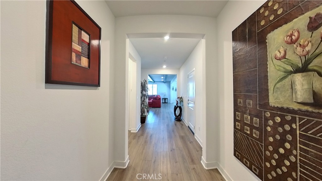 2411 Huron Road Rialto, CA 92377 - Photo 3 of 46 a view of a hallway with wooden floor and closet