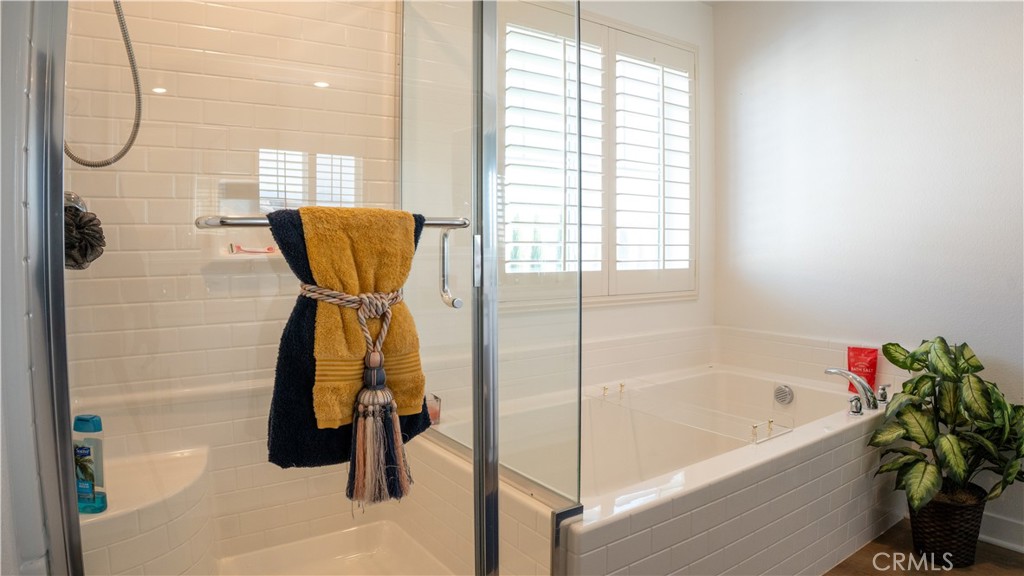 2411 Huron Road Rialto, CA 92377 - Photo 31 of 46 a bathroom with a tub shower and a window