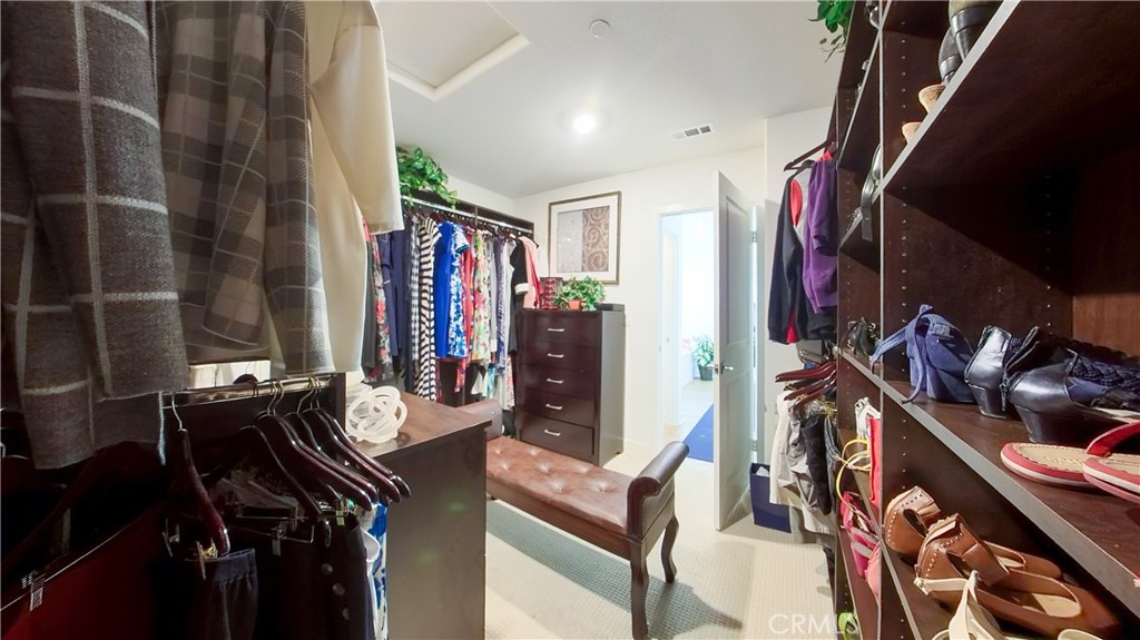 2411 Huron Road Rialto, CA 92377 - Photo 34 of 46 a view of walk in closet with clothes