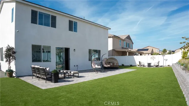 a view of a patio with table and chairs potted plants