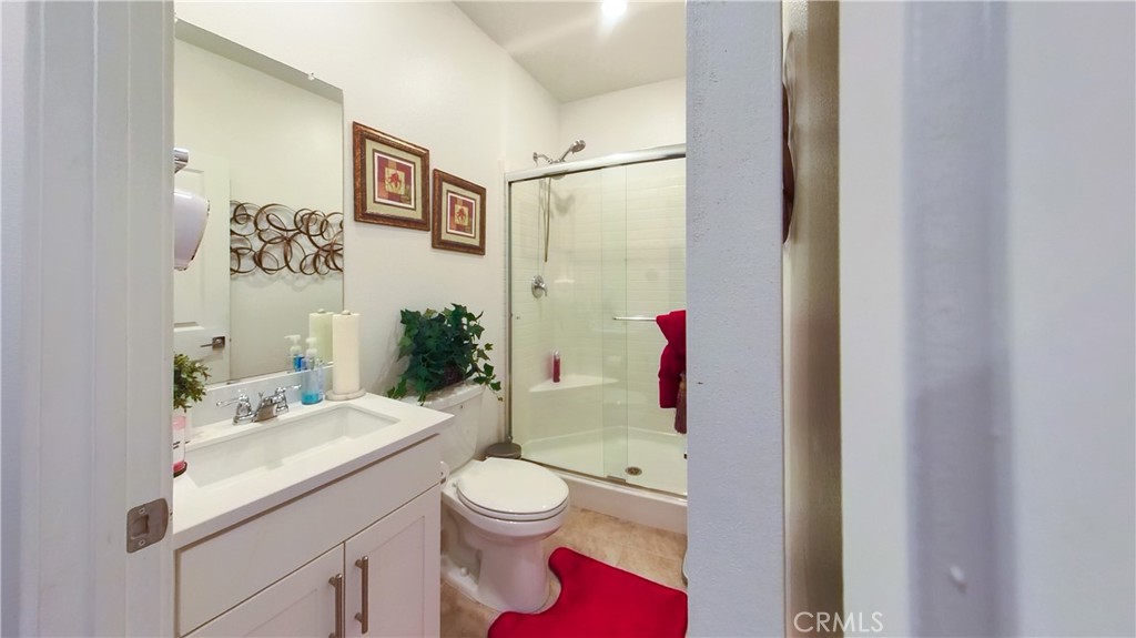 2411 Huron Road Rialto, CA 92377 - Photo 4 of 46 a bathroom with a sink a toilet and a shower curtain