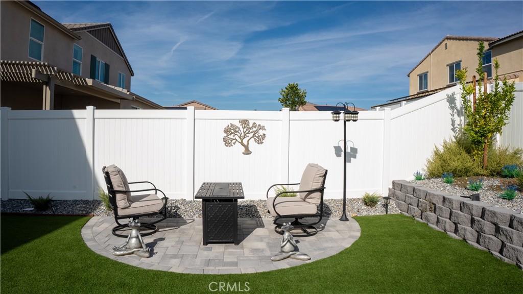 2411 Huron Road Rialto, CA 92377 - Photo 44 of 46 a view of a patio with table and chairs potted plants