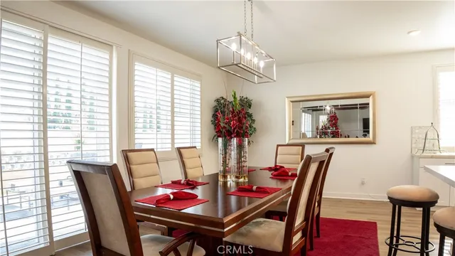 a view of a dining room with furniture wooden floor and chandelier