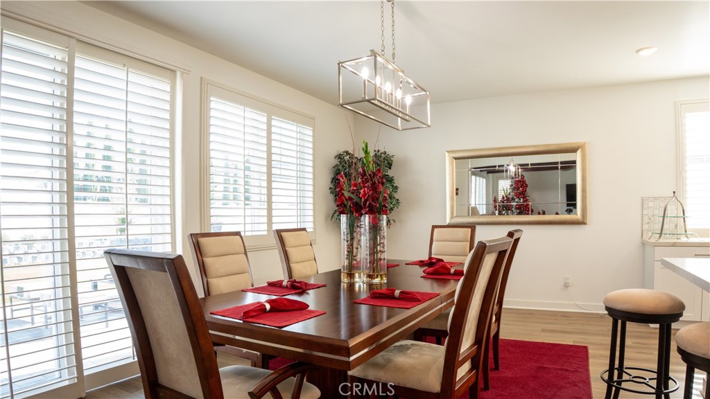 2411 Huron Road Rialto, CA 92377 - Photo 8 of 46 a view of a dining room with furniture wooden floor and chandelier