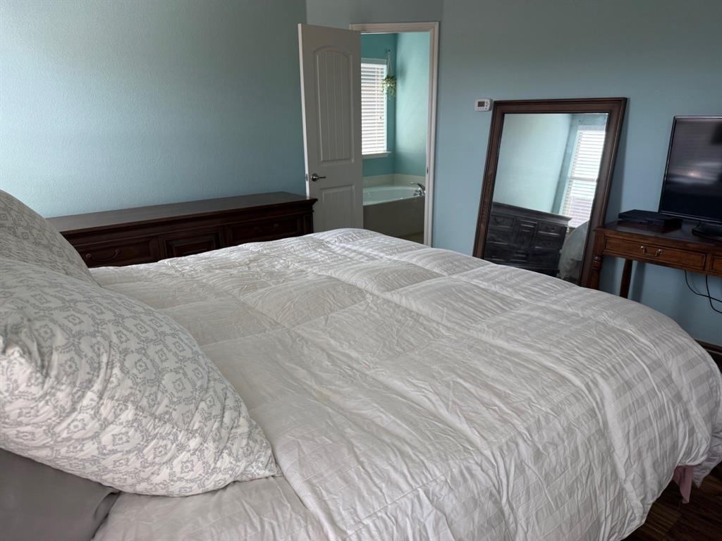 120 Chalk Road Anna, TX 75409 - Photo 17 of 29 a bedroom with a bed and wooden floor