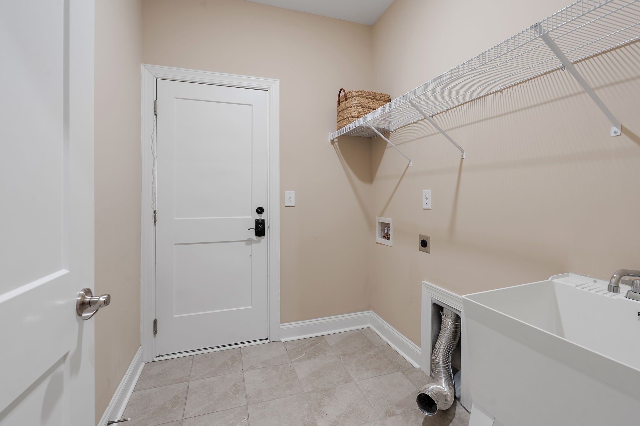 7205 Ragland Place Fairview, TN 37062 - Photo 25 of 36 Laundry room! Features a sink and the door is access to the 1 car garage.