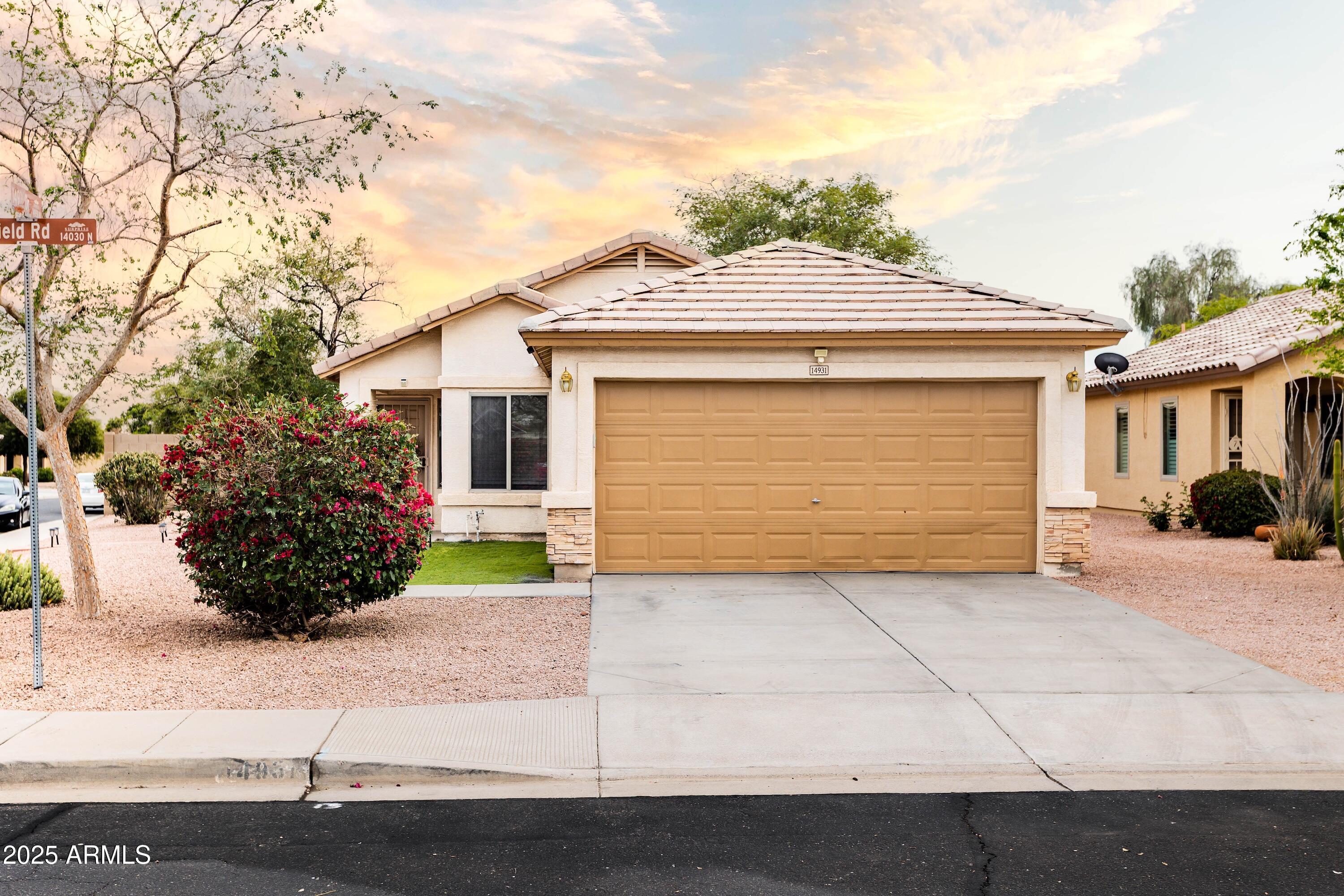 14931 West Redfield Road Surprise, AZ 85379 - Photo 1 of 26 a front view of a house with a garden