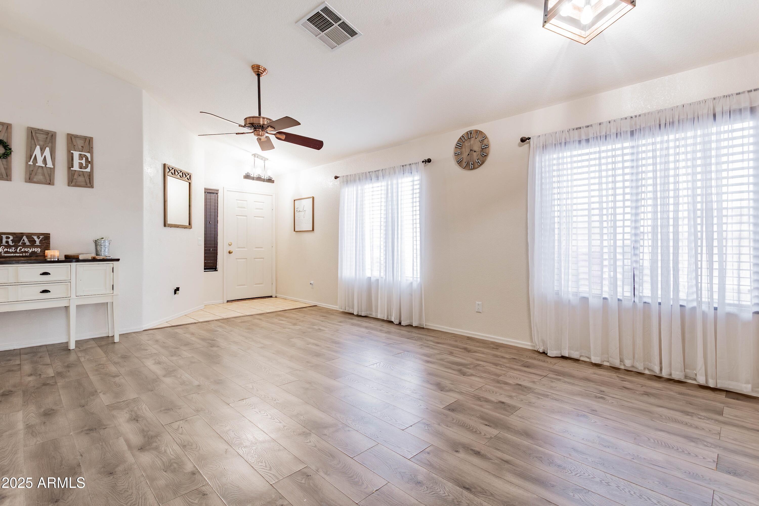 14931 West Redfield Road Surprise, AZ 85379 - Photo 2 of 26 wooden floor in an empty room with a window