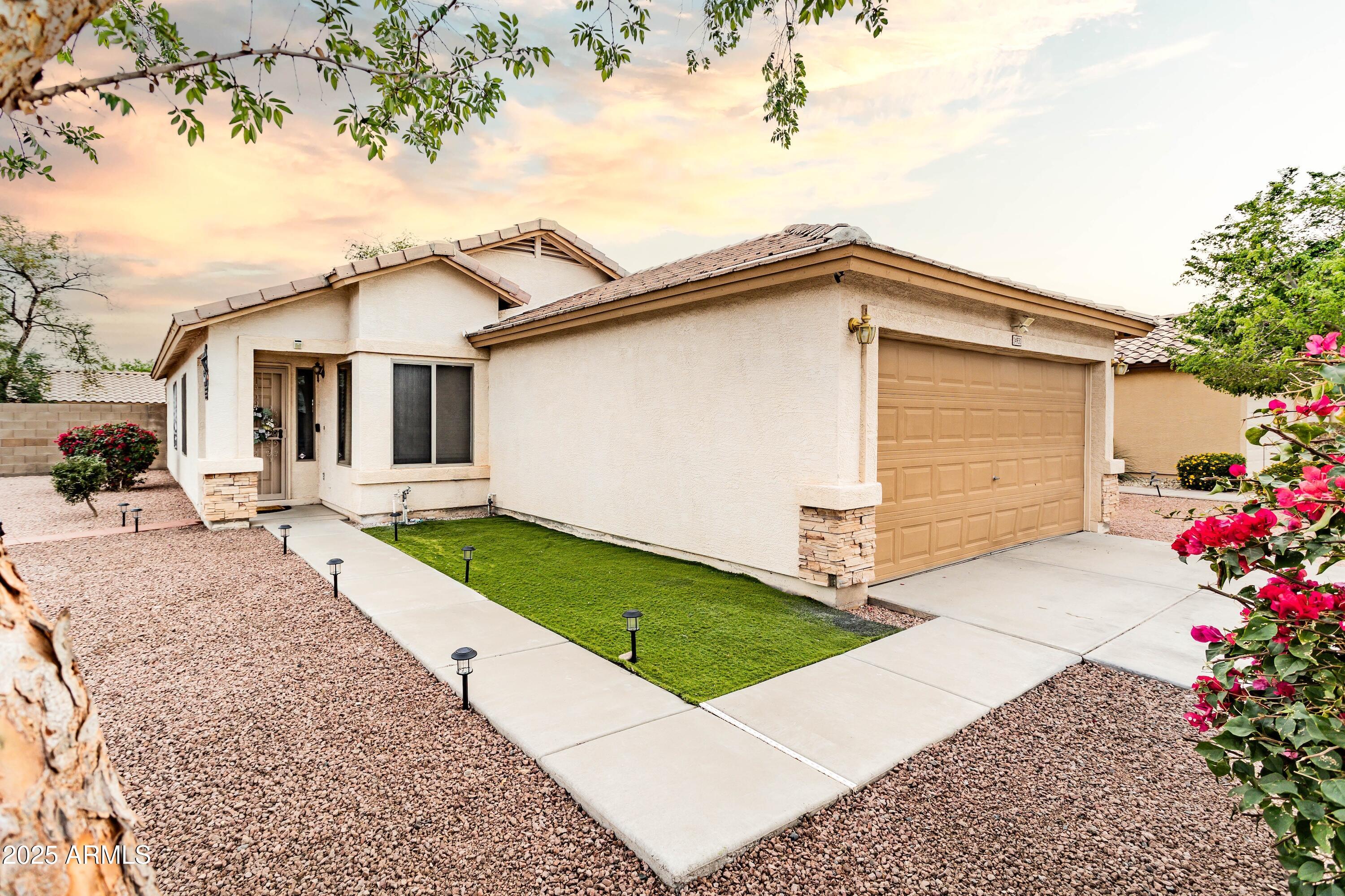 14931 West Redfield Road Surprise, AZ 85379 - Photo 25 of 26 a front view of house with yard and trees around