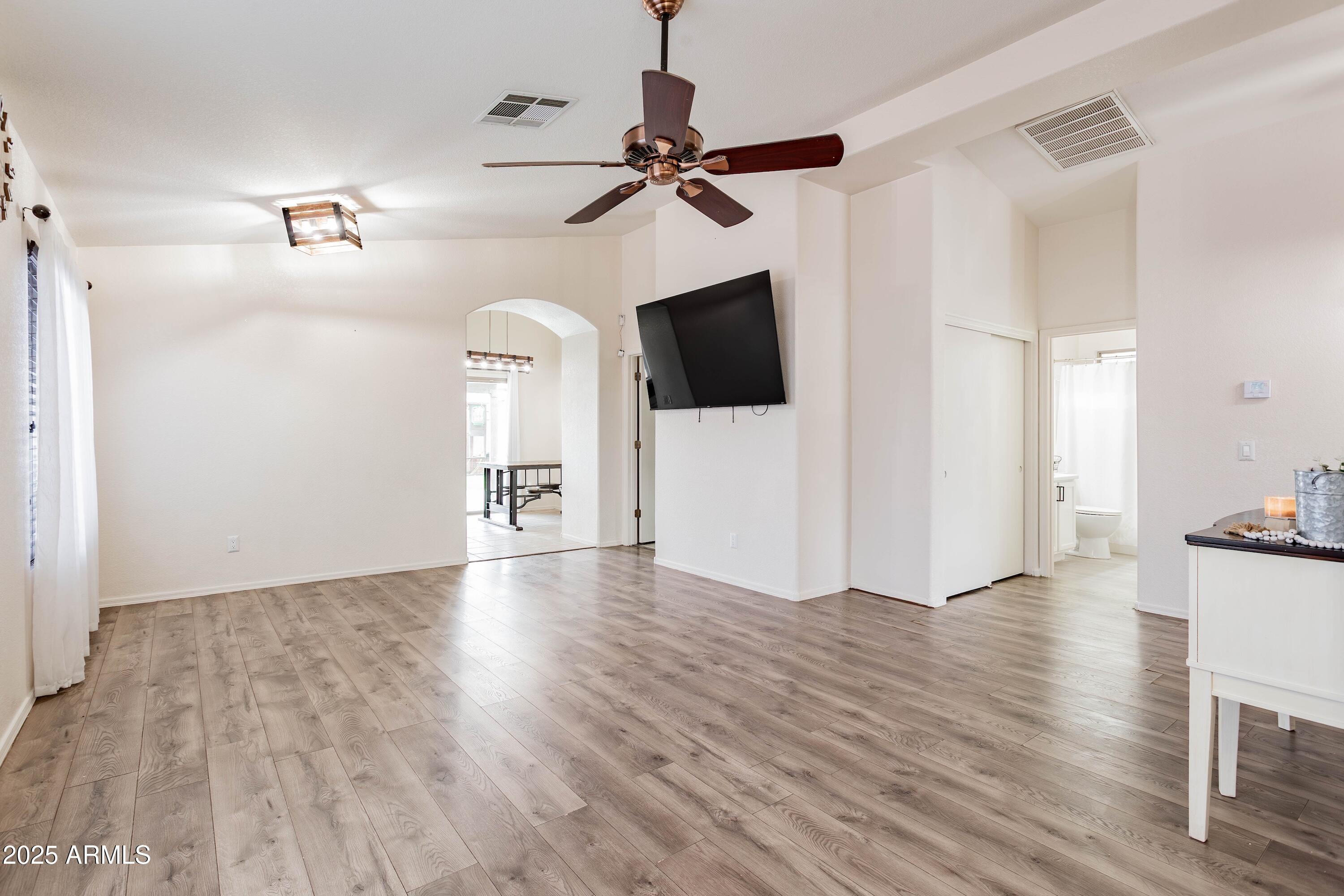 14931 West Redfield Road Surprise, AZ 85379 - Photo 3 of 26 a view of a livingroom with wooden floor