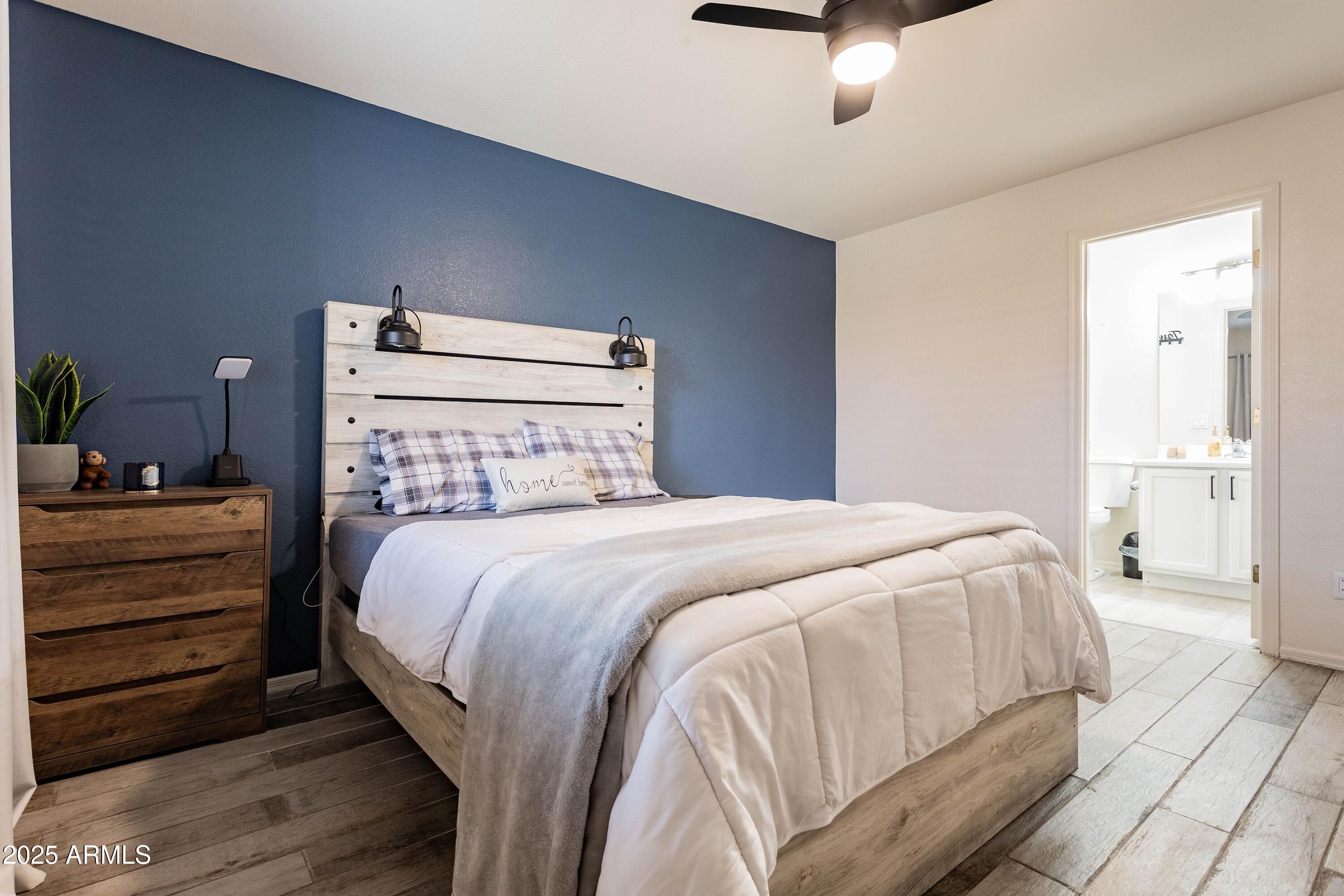 14931 West Redfield Road Surprise, AZ 85379 - Photo 9 of 26 a bedroom with a bed and a dresser