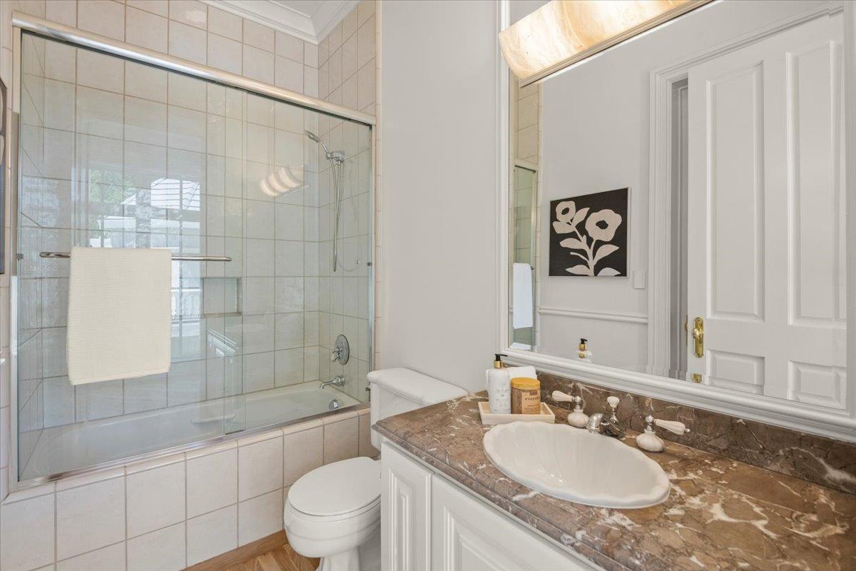 14113 Pike Road Saratoga, CA 95070 - Photo 30 of 78 a bathroom with a granite countertop sink toilet a mirror and shower