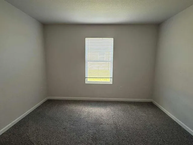 a view of kitchen with refrigerator stove and wooden floor