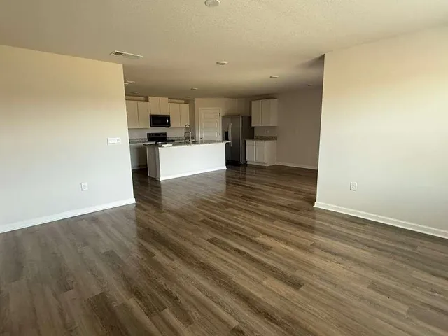 a view of kitchen view wooden floor and electronic appliances