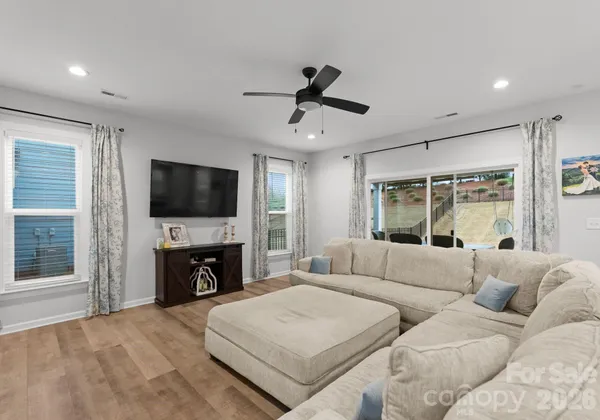 a living room with furniture and kitchen view