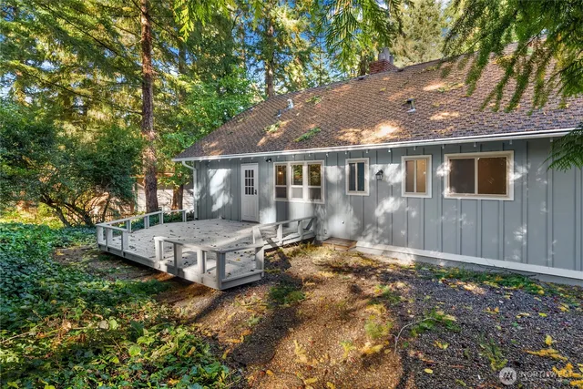 a view of backyard with deck and trees