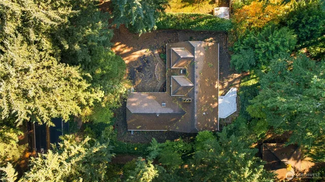 an aerial view of a house with a yard and garden
