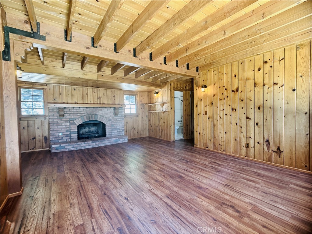 349 Golf Course Road Lake Arrowhead, CA 92352 - Photo 11 of 58 a view of empty room with wooden floor and fireplace