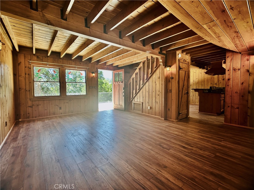 349 Golf Course Road Lake Arrowhead, CA 92352 - Photo 15 of 58 a view of an empty room with wooden floor and a window