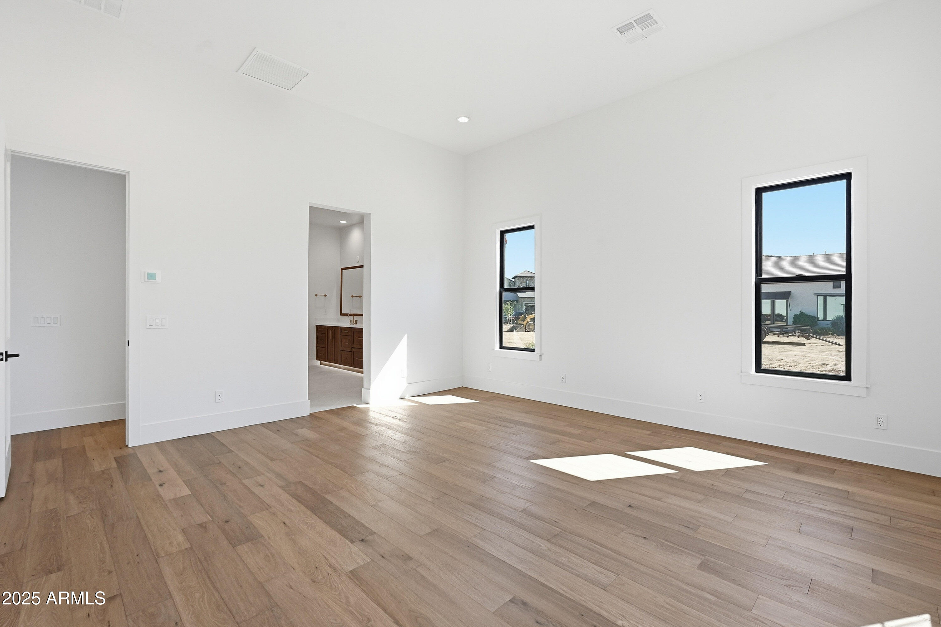 3326 South Stuart Court Gilbert, AZ 85297 - Photo 24 of 88 an empty room with wooden floor and windows