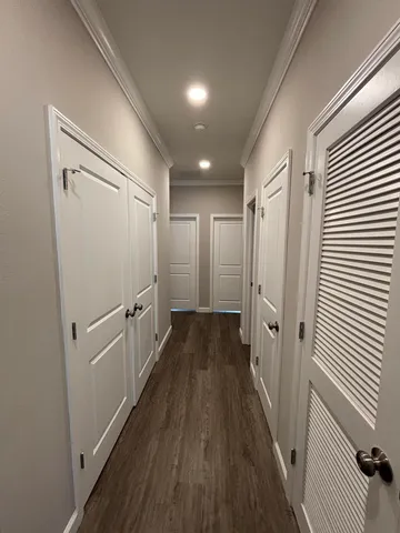 a view of a hallway with wooden floor