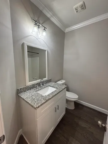 a spacious bathroom with a granite countertop sink and a mirror