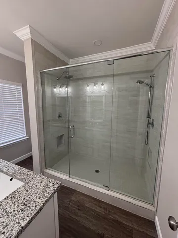 a bathroom with a granite countertop shower and a sink