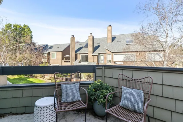 a view of a chairs and table on the roof deck