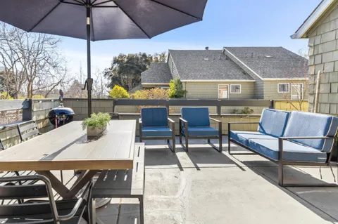 a view of city from balcony with seating space