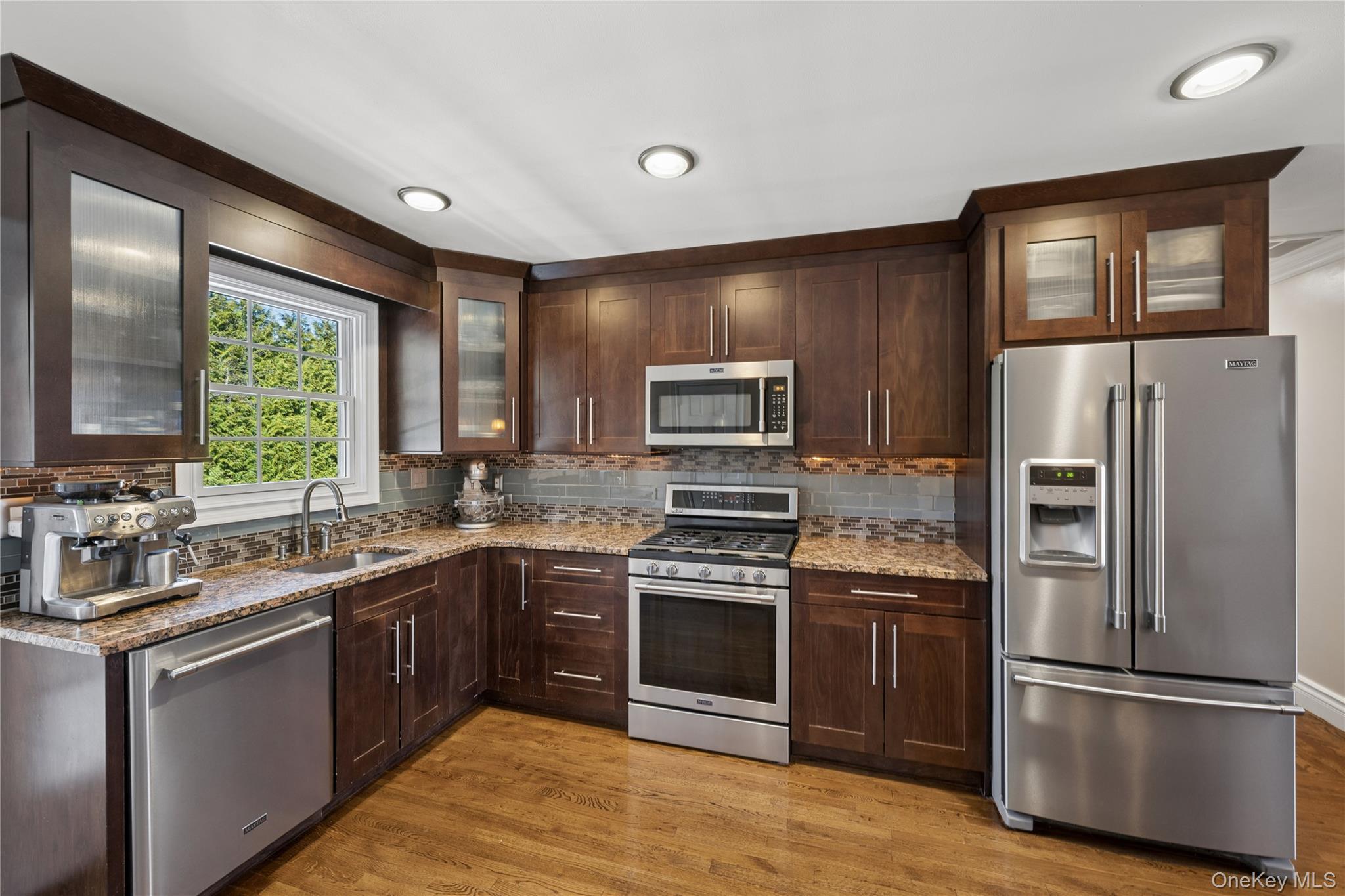 44 Archie Place West Islip, NY 11795 - Photo 12 of 36 a kitchen with stainless steel appliances granite countertop a sink stove and refrigerator