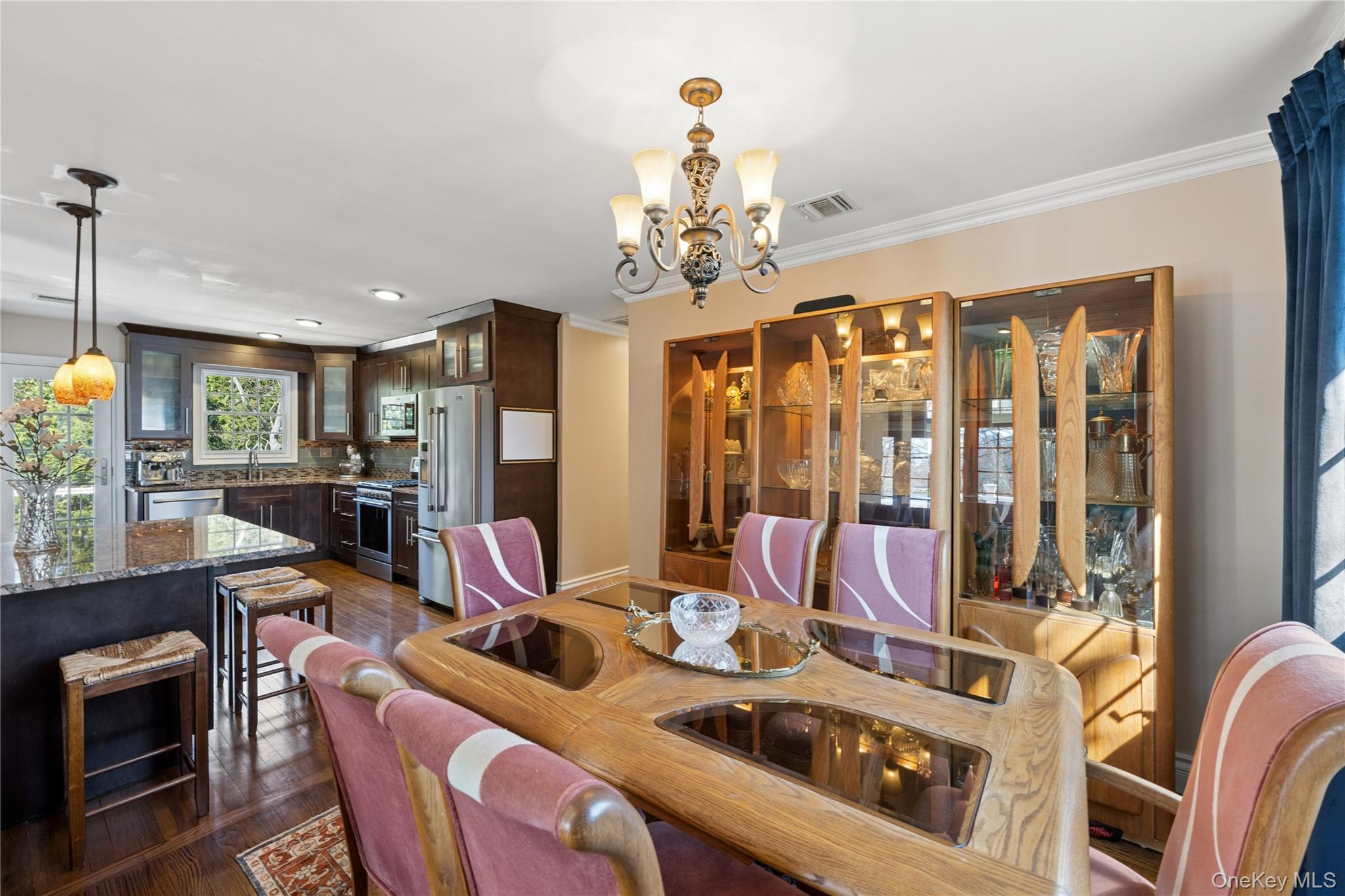 44 Archie Place West Islip, NY 11795 - Photo 13 of 36 a view of a dining room with furniture a chandelier and a large window