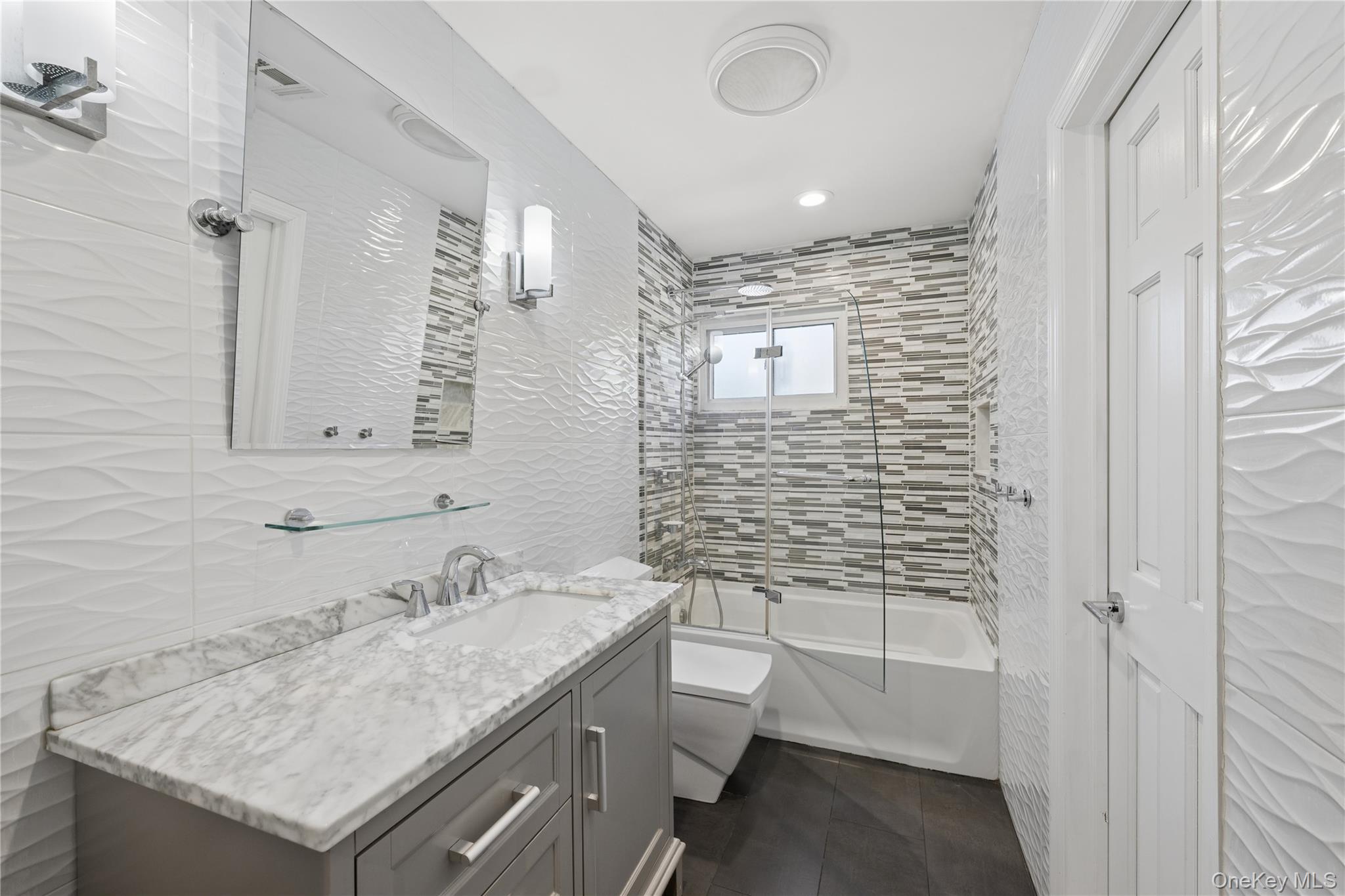 44 Archie Place West Islip, NY 11795 - Photo 18 of 36 a bathroom with a sink a toilet and shower