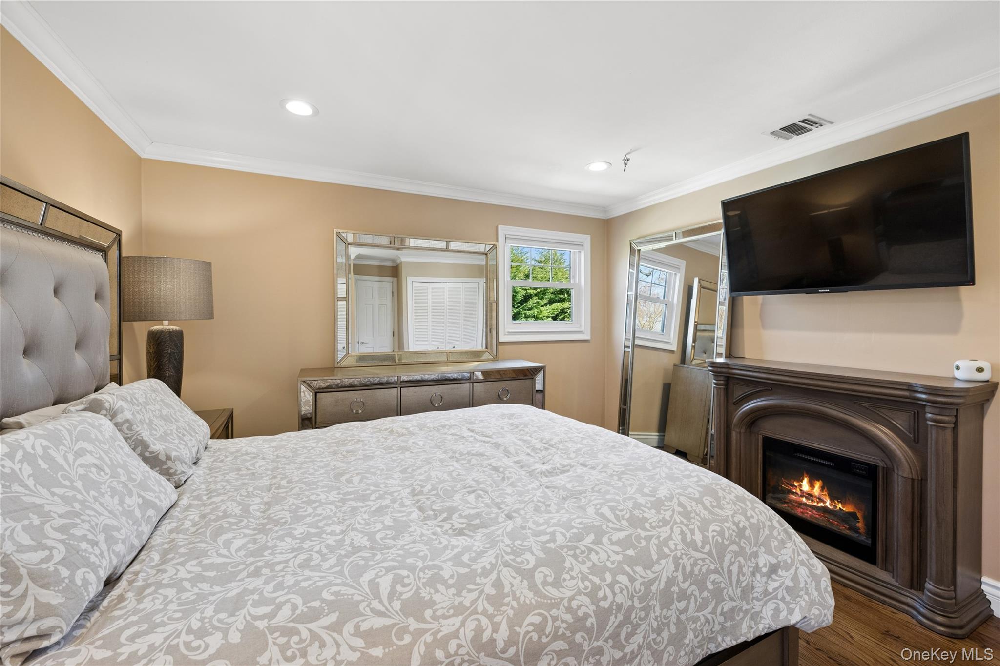 44 Archie Place West Islip, NY 11795 - Photo 10 of 36 a bedroom with a large bed and a flat screen tv