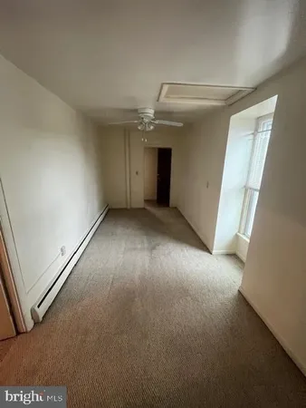an empty room with windows and entrance