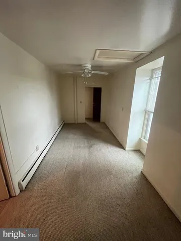 an empty room with windows and entrance